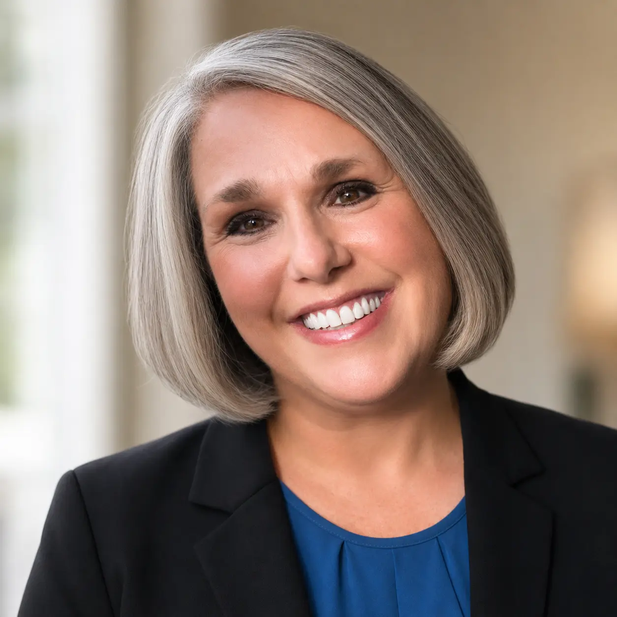 Smiling gray-haired woman in business attire
